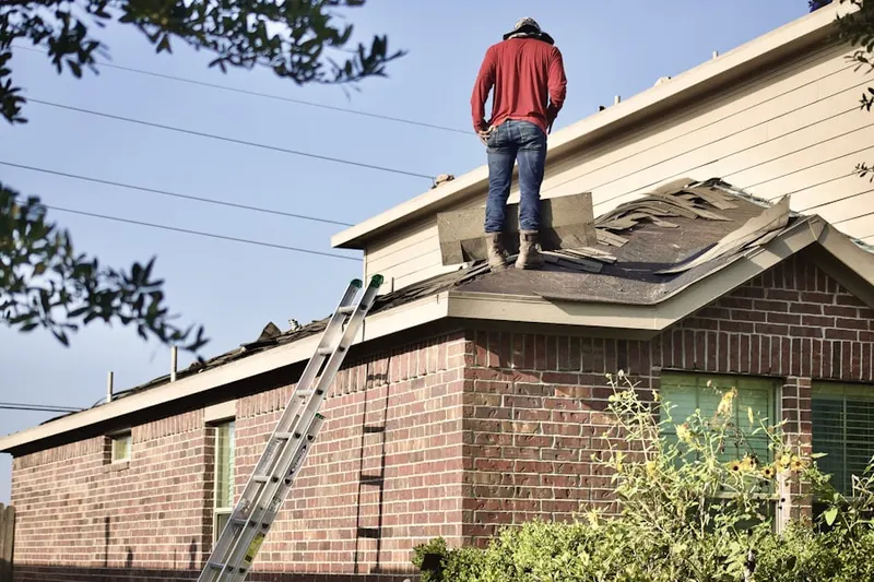 Professional roofer working on a residential roof in Comus Sugarloaf